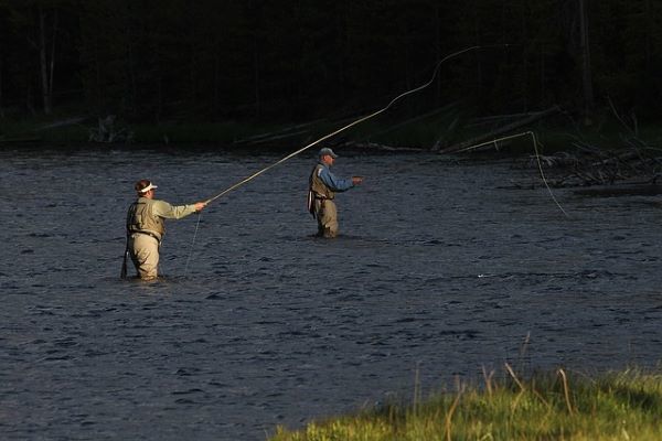Two people are fly fishig in the river